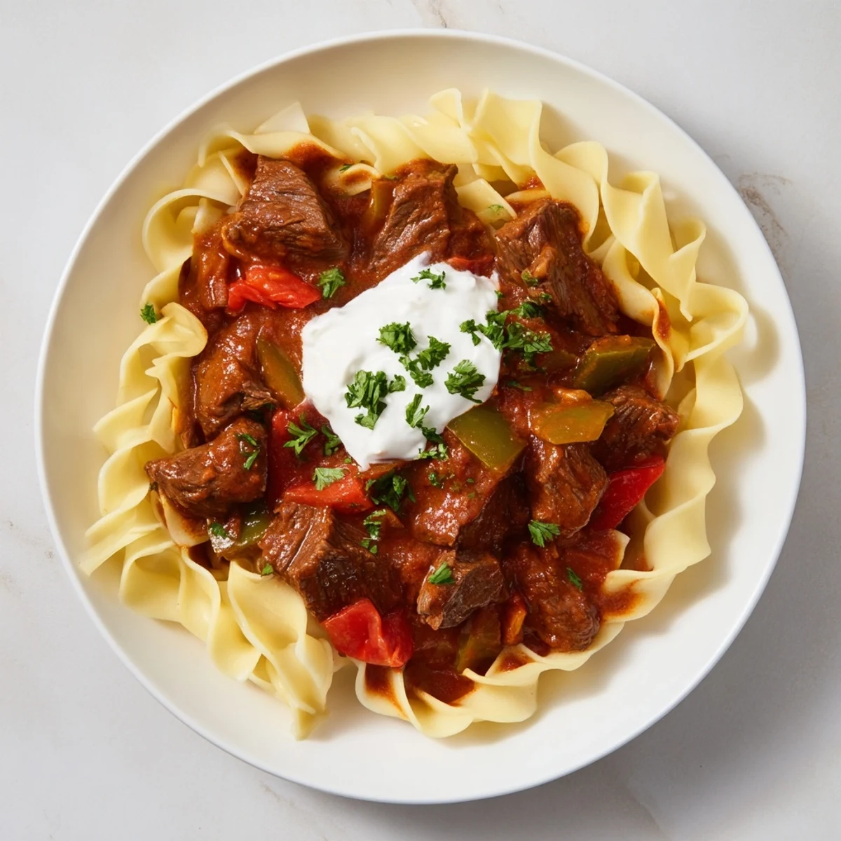 Rich, flavorful Hungarian Goulash boasts perfectly tender beef, served steaming with buttery egg noodles.