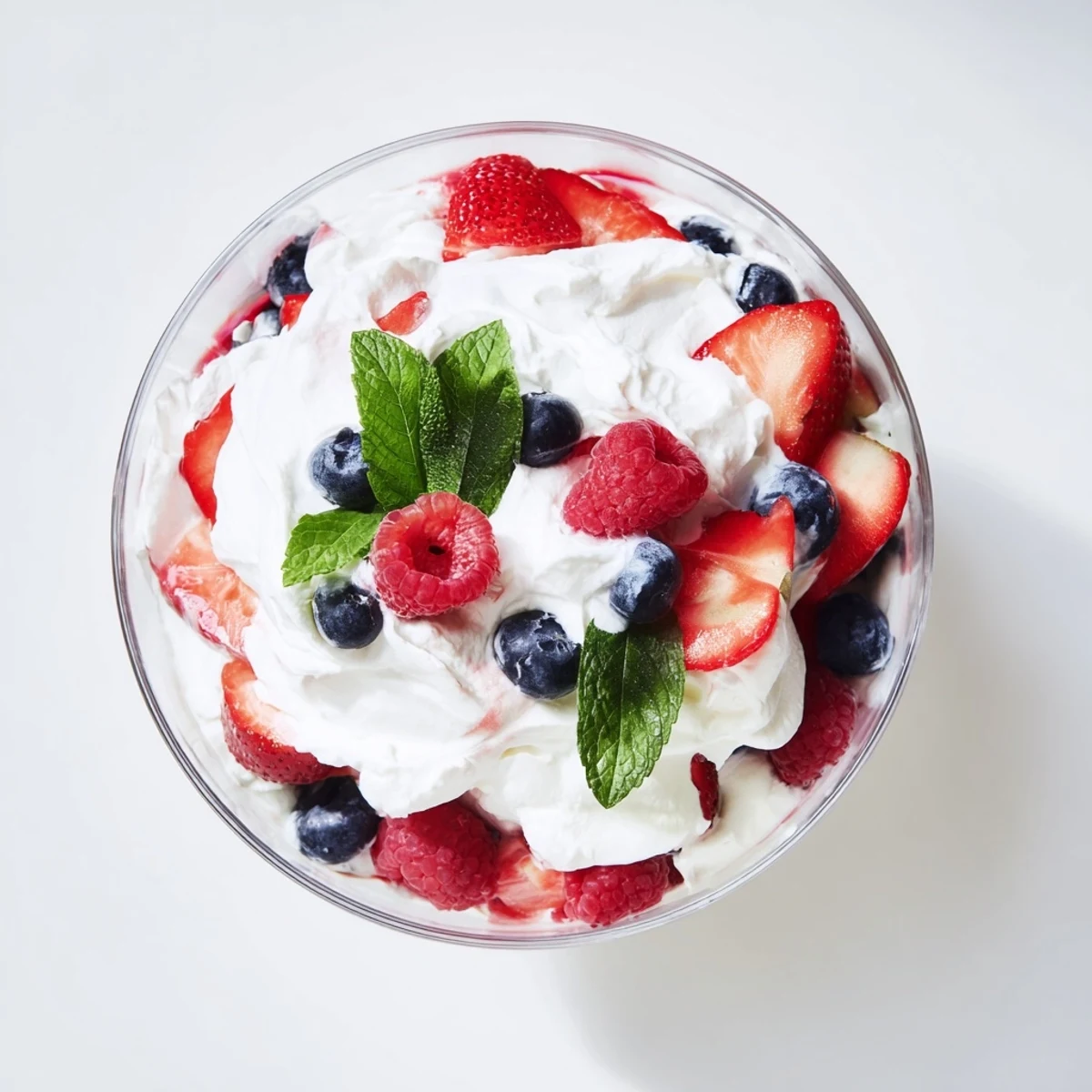 Fresh Berry Parfait layers bursting with vibrant berries and clouds of sweet whipped cream.
