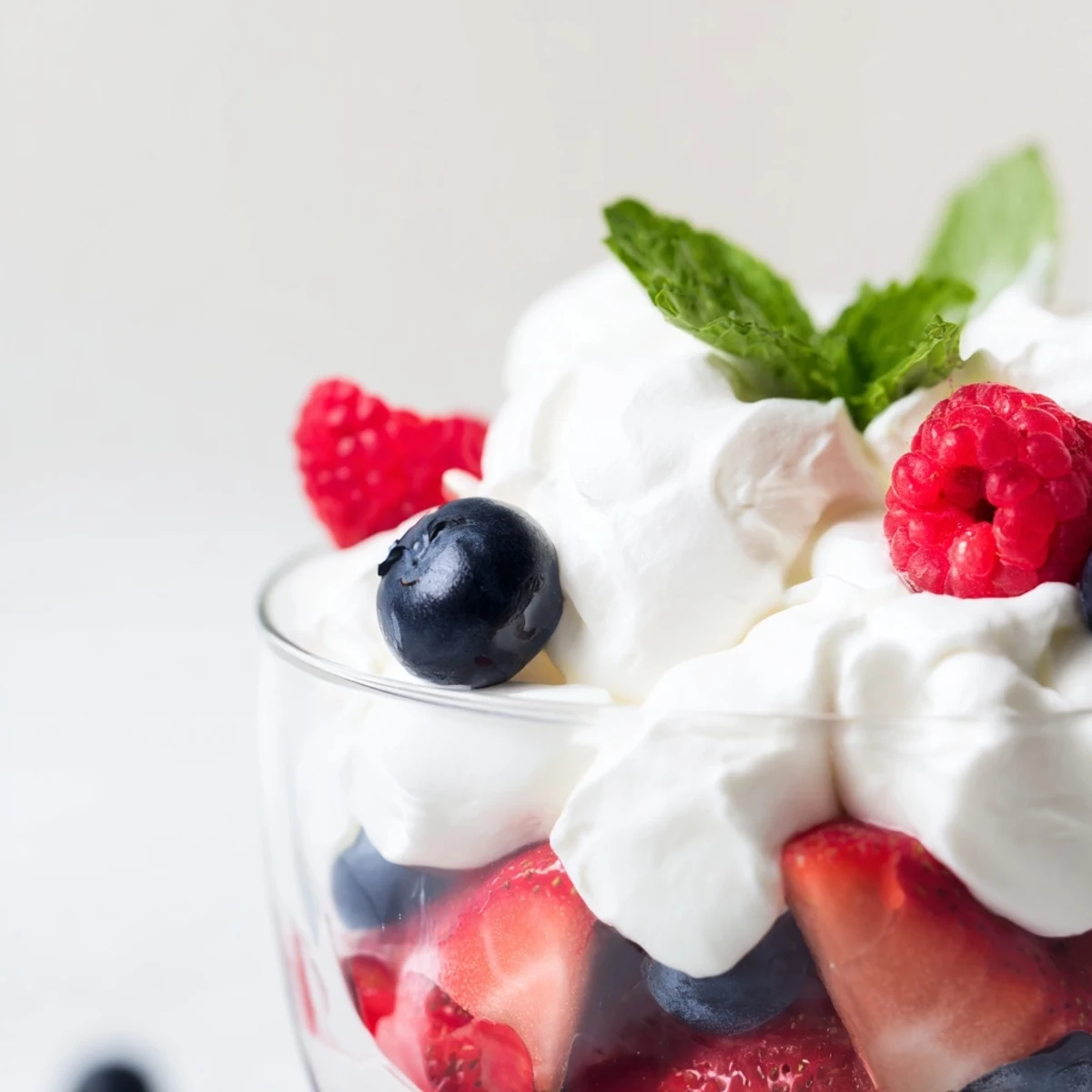 Enjoy a refreshing layered Berry Parfait dessert: easy to assemble for a quick summer treat.