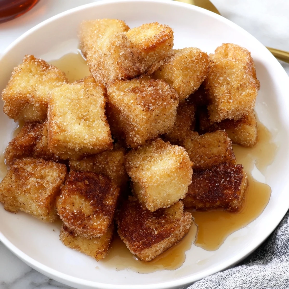 A bowl of delicious French Toast Cereal, these crispy bread cubes, perfect breakfast, with or without milk.