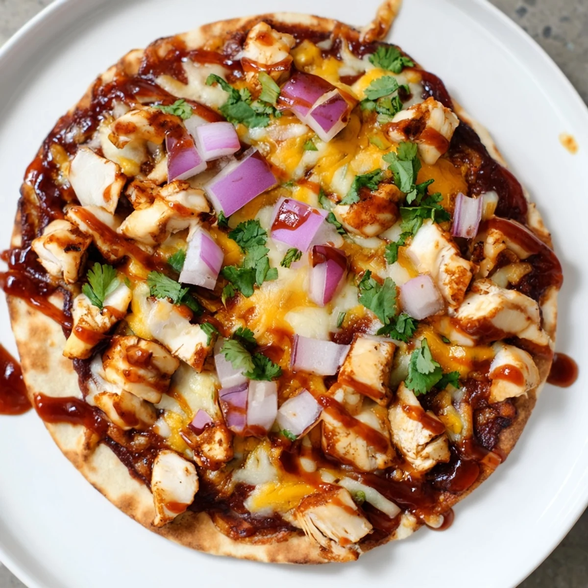 BBQ Chicken Flatbread, a bubbling, cheesy flatbread with vibrant red onion and fresh cilantro.