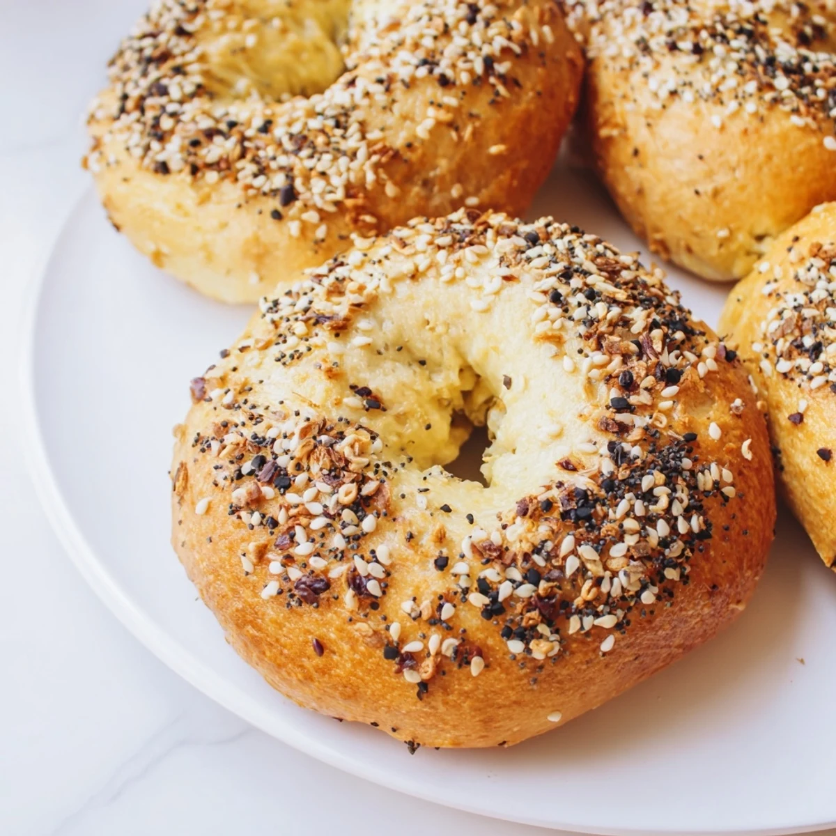 Warm, golden Everything Bagel Yogurt Bagels ready to eat, with a generous topping of savory seasonings.