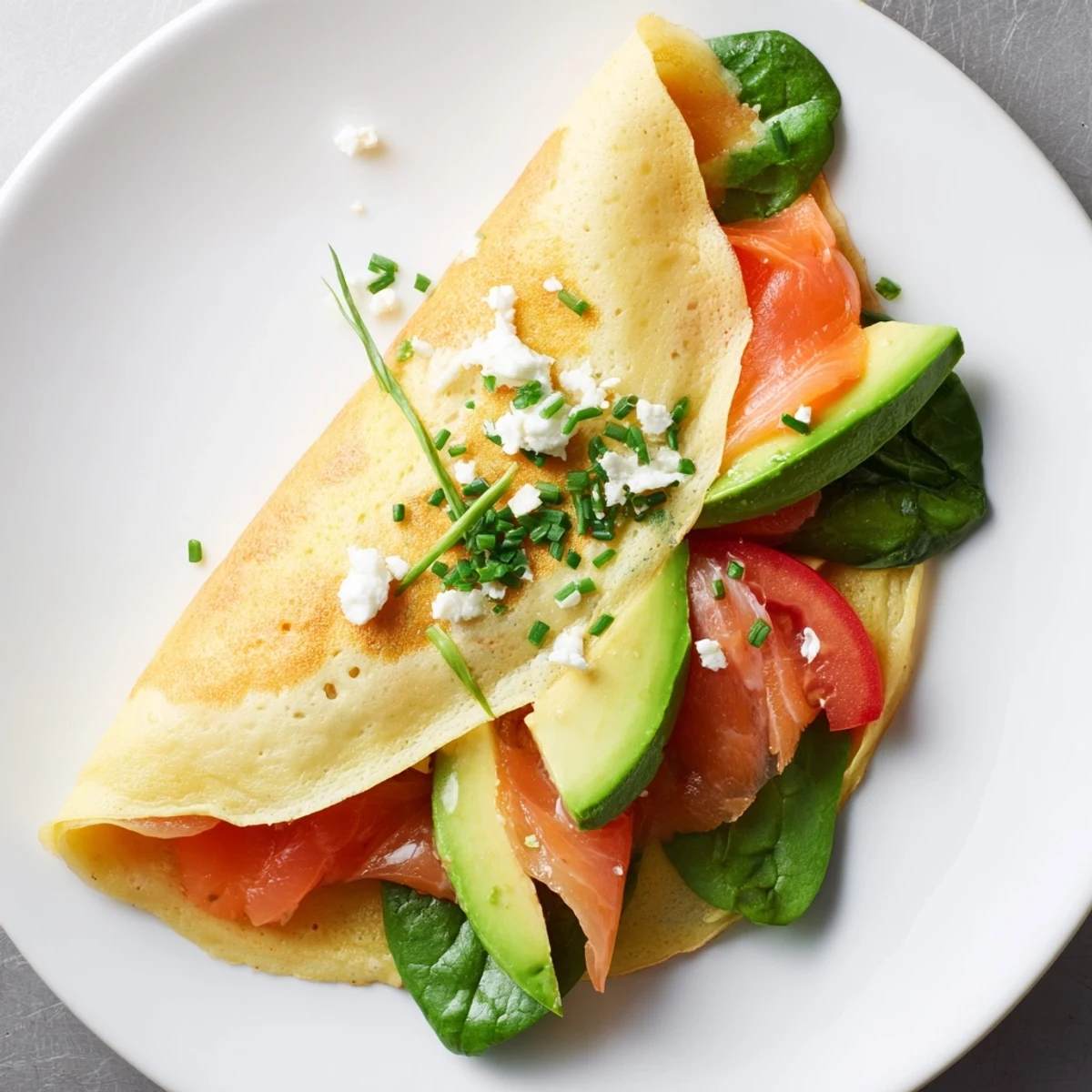 Savory blender egg crepe wrap, thin, delicate, and filled with smoked salmon and fresh herbs.