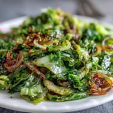 Sautéed Cabbage With Garlic and Mediterranean Spices in a pan, lightly caramelized and served alongside grilled chicken for dinner.