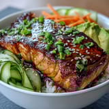2. A colorful 15-minute teriyaki salmon bowl featuring tender glazed salmon atop fluffy rice, fresh veggies, and toasted sesame garnish.
