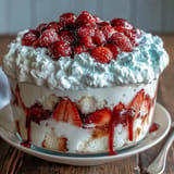 Luscious Red White Blue Berry Trifle, showcasing fluffy cake and fresh fruit swirls.