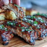 Tender, fall-off-the-bone ribs presented beautifully with three dipping sauce options.