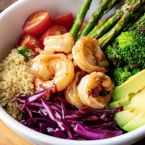 Freshly cooked shrimp and fluffy quinoa shine in this Detox Buddha Bowl, topped with crisp veggies and creamy avocado slices.  