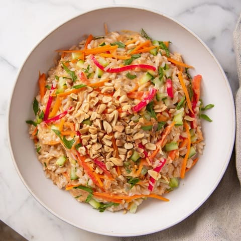 Vibrant Spicy Peanut Noodle Salad with colorful veggies and a creamy, spicy dressing, ready to enjoy.