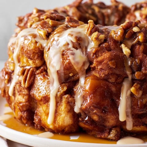 Golden-brown Cinnamon Roll Monkey Bread, pull-apart pieces with a sticky, caramelized coating.