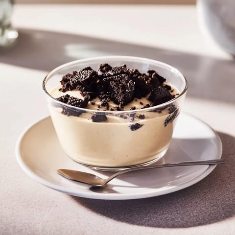 A layered dessert featuring homemade vanilla pudding with a generous Oreo sprinkle.
