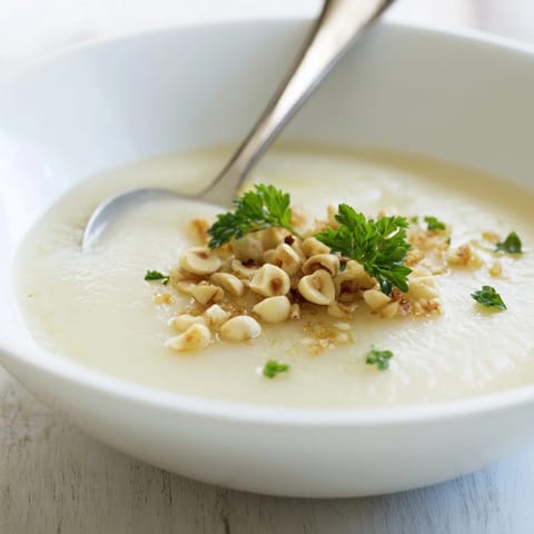 Roasted celeriac and potatoes blended into a velvety soup topped with crunchy hazelnut crumble.  
