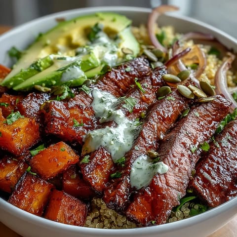 Butternut squash steak bowls feature juicy seared steak, smoky spices, and a lively lime-cilantro dressing.