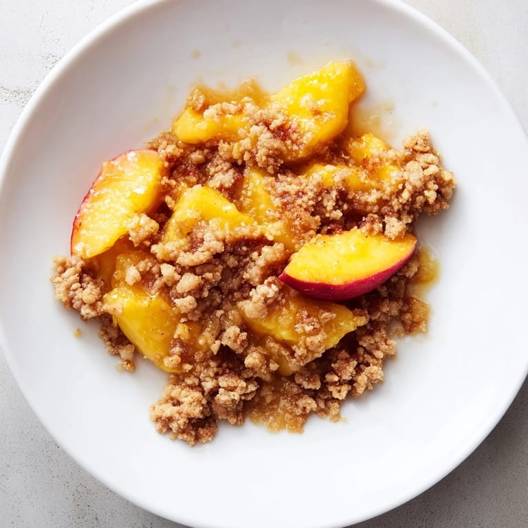 Buttery, crumbly topping crowns the spiced peach filling of this easy Peach and Ginger Crumble.