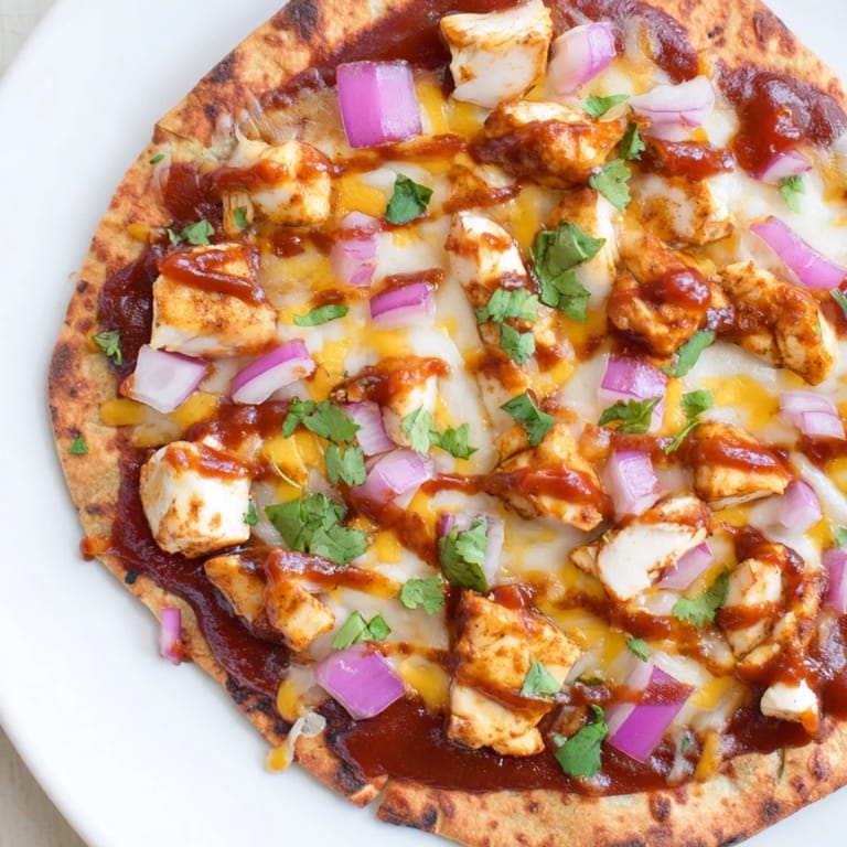 Mouthwatering image of a delicious BBQ Chicken Flatbread, perfect for a casual homemade meal.