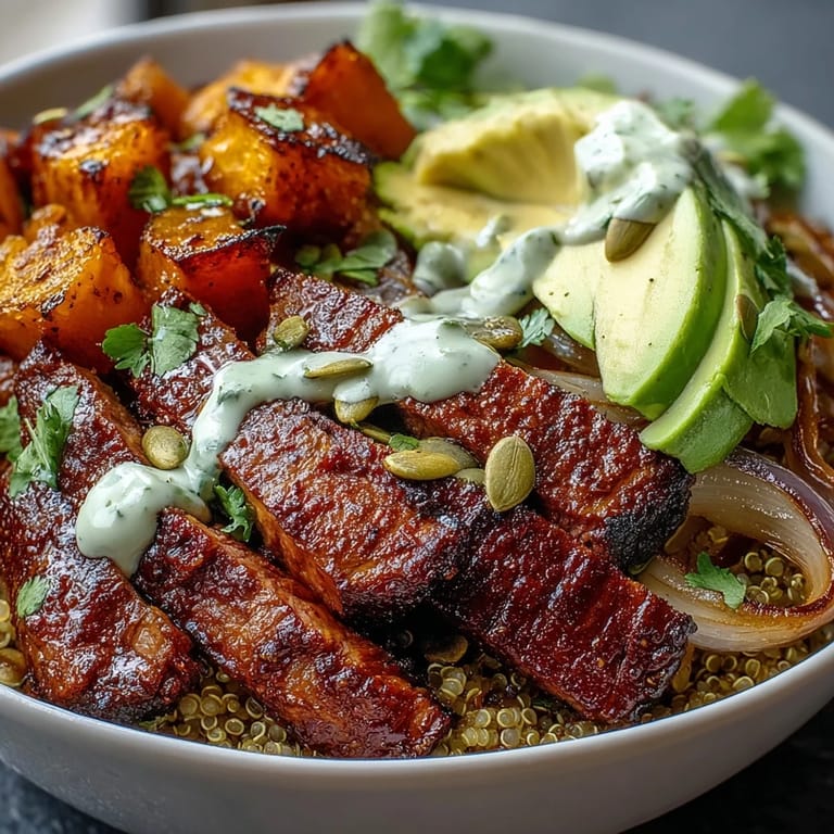 A close-up of butternut squash steak bowls shows tender squash, toasted pepitas, and red onion on greens.