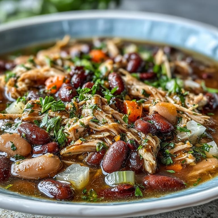 Slow-cooked 15-bean soup with shredded smoked turkey and vegetables, offering a satisfying, gluten-free dinner with deep, hearty flavors.